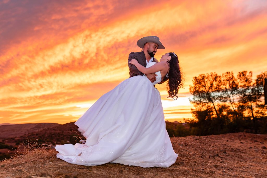 Bride and groom embracing at sunset on their wedding day